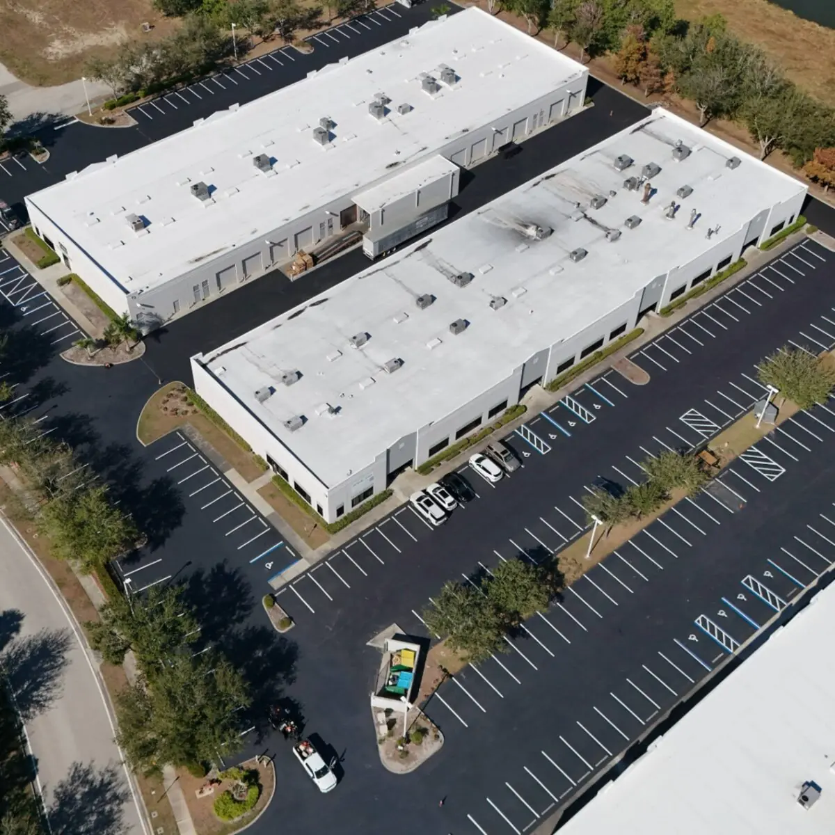 Aerial view of a two building commercial complex with fully striped parking lot in Southwest Florida