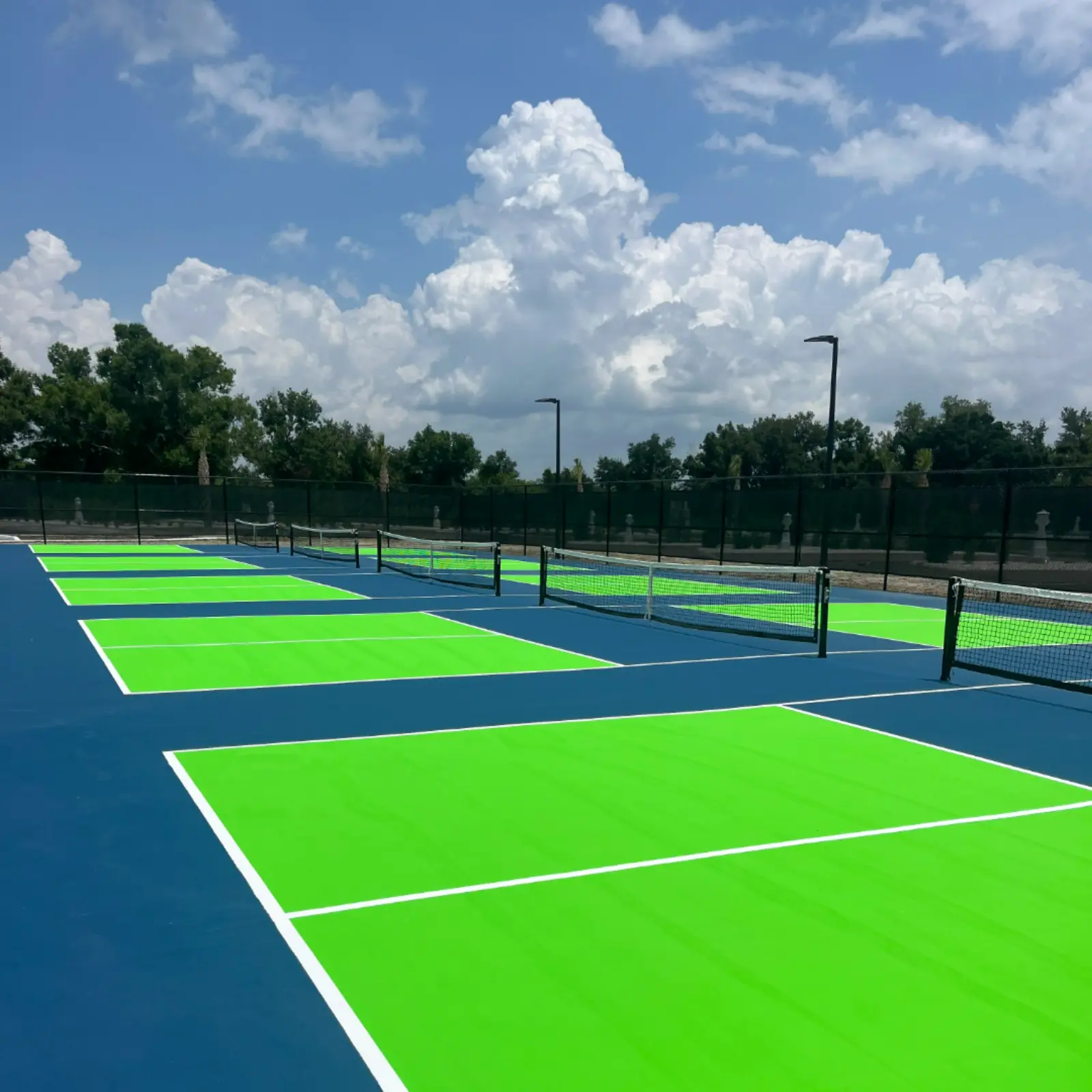 Newly resurfaced pickleball courts with green and blue coating