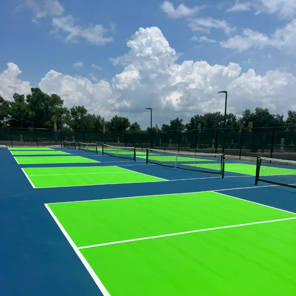 Newly constructed multi court community pickleball complex with blue and green acrylic surface in Southwest Florida