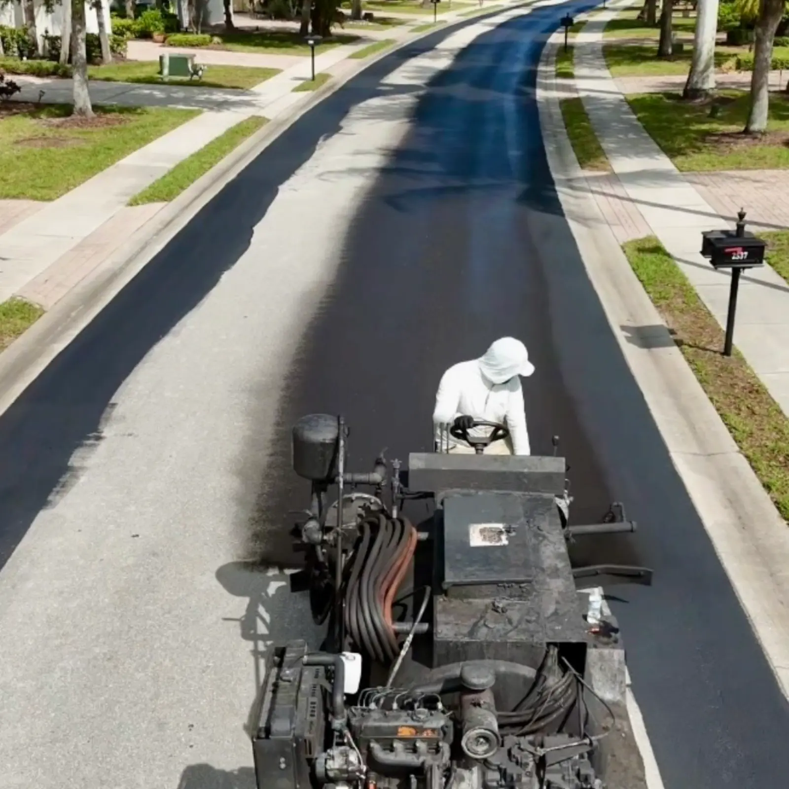 Community road sealcoating in progress