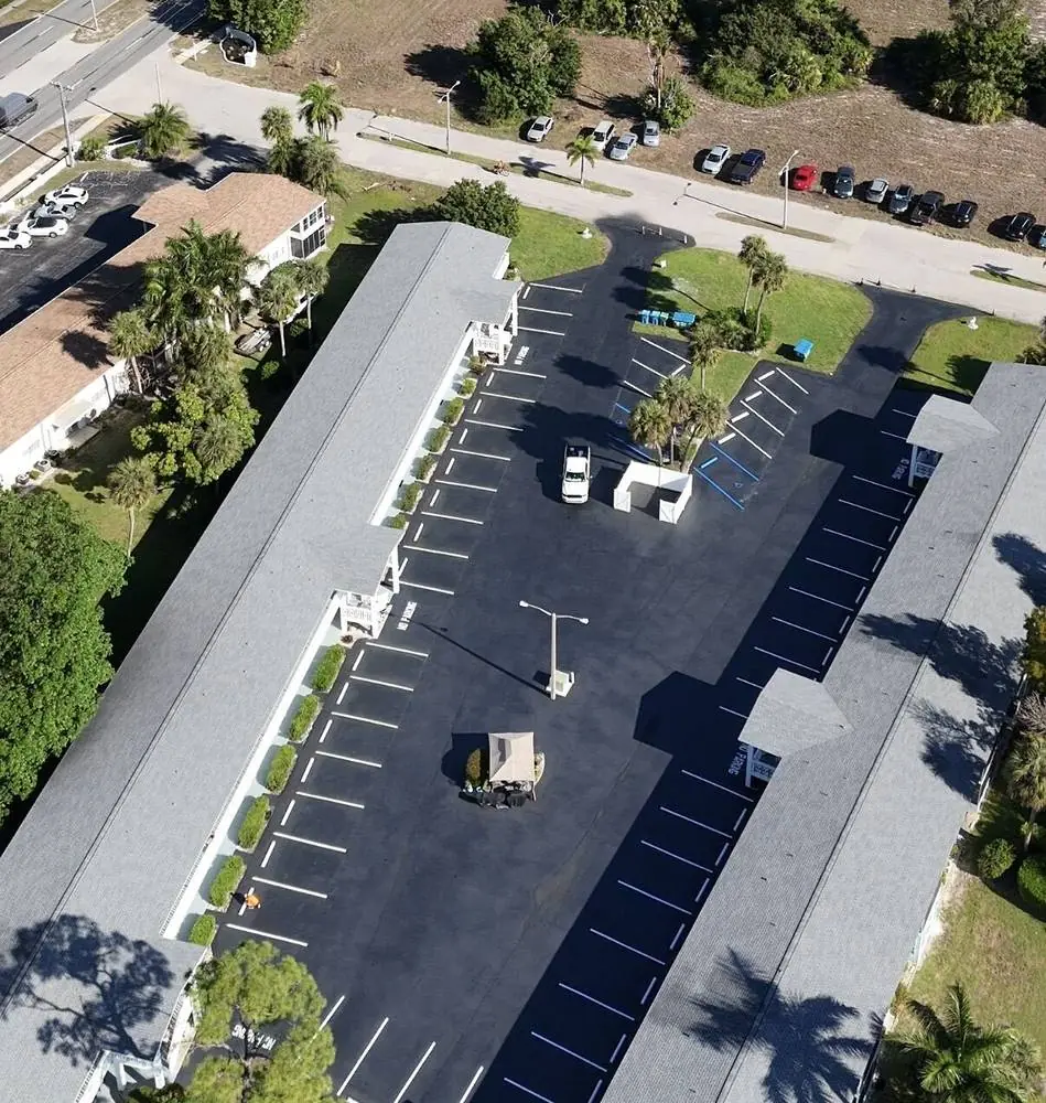 Aerial view of a freshly sealcoated and striped condo community parking lot in Southwest Florida