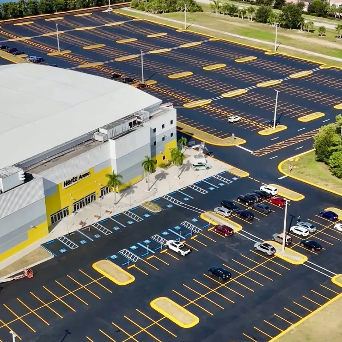 Aerial view of the freshly sealcoated and striped parking lot at Hertz Arena in Estero Florida by Florida Sealcoat and Striping