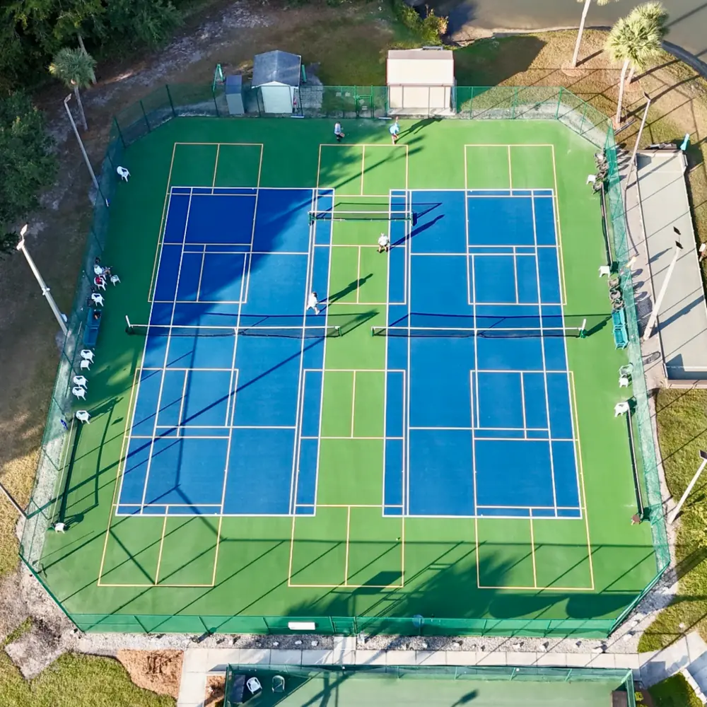 Aerial view of multi use tennis and pickleball courts with blended line layouts in Southwest Florida