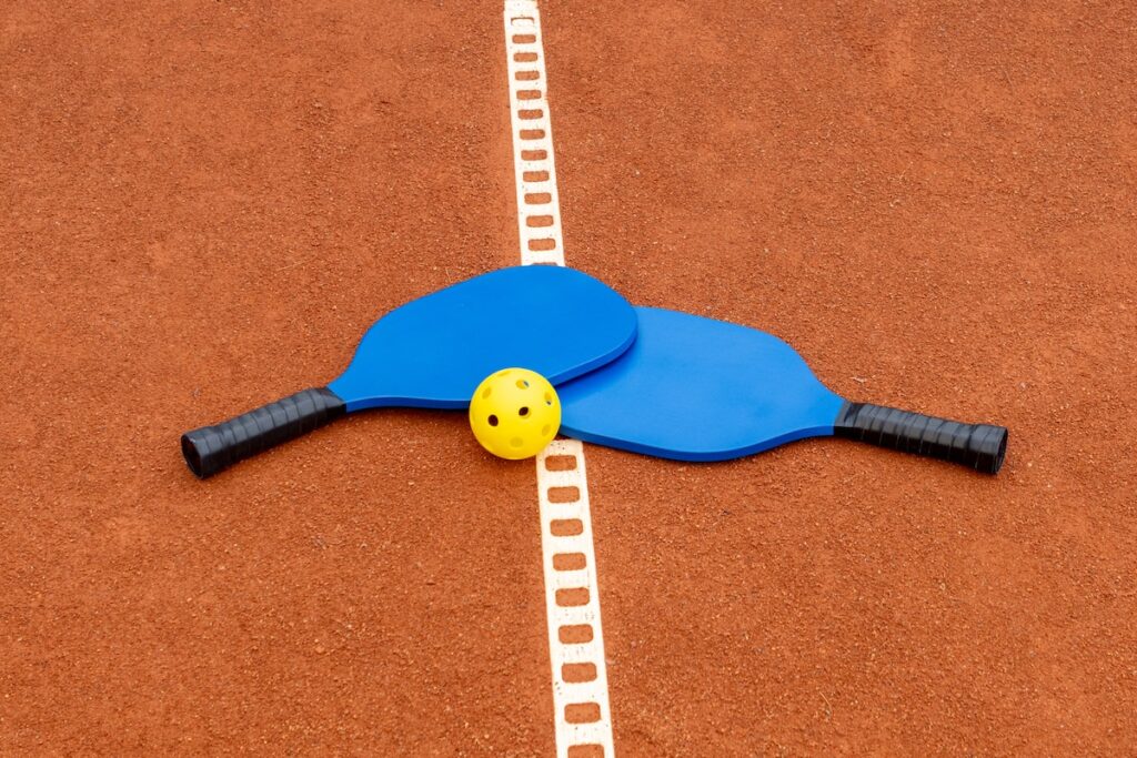Pickleball racket with a smiley face on it